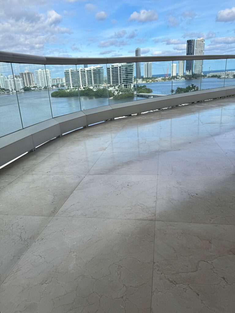 White marble floor on a balcony overlooking a city.